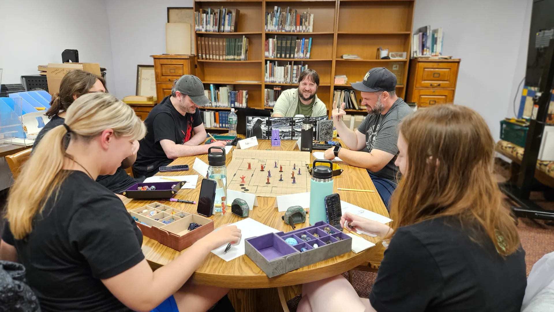 The Tabletop Society helping guests learn a game